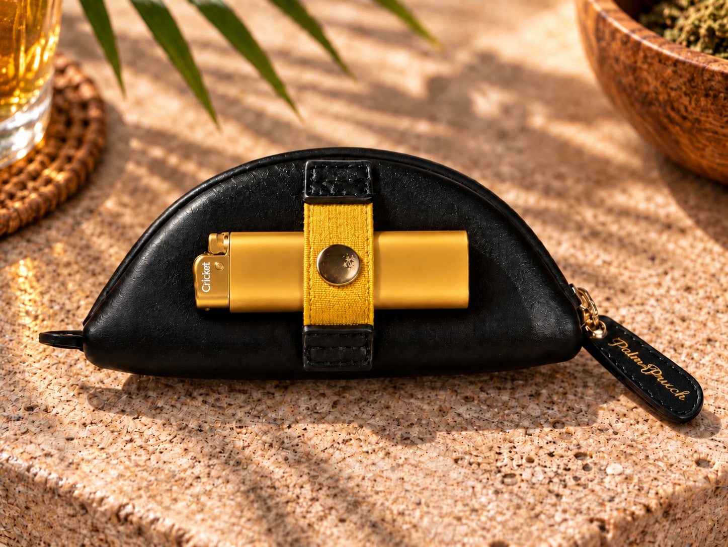 Gold lighter secured beneath the rear Black PalmPouch strap